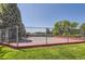 Fenced community tennis court in good condition and surrounded by lush greenery at 7500 E Dartmouth Ave # 22, Denver, CO 80231
