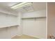A spacious walk-in closet features built-in shelving, plenty of hanging space and carpeted floors at 7500 E Dartmouth Ave # 22, Denver, CO 80231