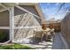 Outdoor dining area with a wooden table and chairs on the backyard patio at 1644 S Lafayette St, Denver, CO 80210
