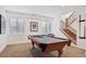 Finished basement with a pool table, carpeted floor, staircase and recessed lighting at 1644 S Lafayette St, Denver, CO 80210