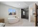 Luxurious bathroom featuring a freestanding tub, a glass-enclosed shower, and elegant tile work at 1644 S Lafayette St, Denver, CO 80210
