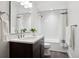 Modern bathroom featuring a sleek vanity, stylish fixtures, and a tiled shower-tub combination with a shower curtain at 1644 S Lafayette St, Denver, CO 80210