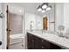 Well-lit bathroom with granite countertop vanity and mosaic tiled shower/tub combo at 1644 S Lafayette St, Denver, CO 80210