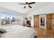 Comfortable bedroom features large window, hardwood floors, ceiling fan, and an attached closet at 1644 S Lafayette St, Denver, CO 80210