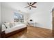 Bright bedroom features hardwood floors, a ceiling fan, and a built-in workstation near the window at 1644 S Lafayette St, Denver, CO 80210