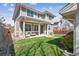 Charming two-story home with a covered front porch, well-kept lawn, and lush landscaping at 1644 S Lafayette St, Denver, CO 80210