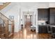 Bright foyer with hardwood floors, a staircase, and a glimpse of the front door and kitchen at 1644 S Lafayette St, Denver, CO 80210