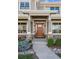 Inviting front entrance featuring a stylish wood door, stone accents, and a cozy covered porch for relaxation at 1644 S Lafayette St, Denver, CO 80210