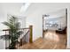 Bright hallway with skylight, hardwood floors, and view into the bedroom at 1644 S Lafayette St, Denver, CO 80210