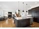 Open-concept kitchen with granite island overlooks living area and staircase, perfect for entertaining at 1644 S Lafayette St, Denver, CO 80210