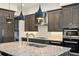 Spacious kitchen featuring modern appliances, granite countertops and a large island with sink at 1644 S Lafayette St, Denver, CO 80210