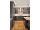 Modern kitchen featuring sleek cabinetry, stainless steel appliances, granite countertops and hardwood floors at 1644 S Lafayette St, Denver, CO 80210