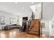 Open-concept living space with hardwood floors, fireplace, and staircase creates a welcoming atmosphere at 1644 S Lafayette St, Denver, CO 80210