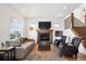 Inviting living room with a cozy fireplace, neutral decor, and a staircase at 1644 S Lafayette St, Denver, CO 80210