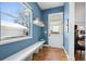 Mudroom entrance with blue walls, bench seating, window and coat hooks at 1644 S Lafayette St, Denver, CO 80210