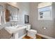 Stylish powder room with patterned wallpaper, a pedestal sink, and a modern toilet at 1644 S Lafayette St, Denver, CO 80210