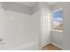 Bathroom with white tile and wood floor at 13633 E Yale Ave # B, Aurora, CO 80015
