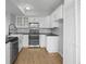 Updated kitchen boasting white cabinets, black countertops, stainless steel appliances, and modern fixtures at 13633 E Yale Ave # B, Aurora, CO 80015