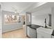 Bright kitchen with stainless appliances, farmhouse sink, open to the dining area, and natural light at 13633 E Yale Ave # B, Aurora, CO 80015