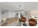 Bright living room featuring soaring ceilings, modern furniture, wood floors, and slider to a private patio at 13633 E Yale Ave # B, Aurora, CO 80015