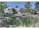 Scenic view of a pond with a bridge and surrounding greenery near residential buildings on a sunny day at 13633 E Yale Ave # B, Aurora, CO 80015