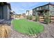 Backyard featuring an artificial turf area, landscaping, a wooden fence and scenic views of the neighborhood at 12628 Bayshore St, Firestone, CO 80504