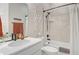 Modern bathroom with stylish fixtures, a clean vanity with a marble countertop, and a shower-tub combination with a neutral color palette at 12628 Bayshore St, Firestone, CO 80504