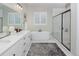 Modern bathroom with double sinks, a freestanding tub, and a glass-enclosed shower at 12628 Bayshore St, Firestone, CO 80504