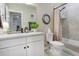 Bathroom featuring modern white cabinets, a toilet, and a shower-tub combo with a shower curtain at 12628 Bayshore St, Firestone, CO 80504