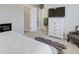 Comfortable bedroom featuring plush carpet, a fireplace, and a white dresser with a TV at 12628 Bayshore St, Firestone, CO 80504