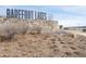 Entrance to the Barefoot Lakes community with a stone sign and native landscaping at 12628 Bayshore St, Firestone, CO 80504