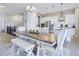 Open-concept dining area with a large wooden table and stylish seating at 12628 Bayshore St, Firestone, CO 80504