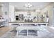 Spacious dining room featuring a large wooden table and bench seating, open to the modern kitchen at 12628 Bayshore St, Firestone, CO 80504