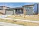 Charming single-story home with a well-manicured front yard and covered porch, featuring a 2-car garage and neutral exterior paint at 12628 Bayshore St, Firestone, CO 80504