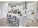 Modern kitchen with white cabinets, a center island, and stainless steel appliances at 12628 Bayshore St, Firestone, CO 80504