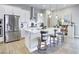 Modern kitchen with stainless steel appliances, white cabinets, large island, and pendant lighting at 12628 Bayshore St, Firestone, CO 80504
