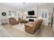 Cozy living room featuring comfortable seating, a fireplace, and bright windows at 12628 Bayshore St, Firestone, CO 80504
