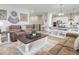 Open-concept living area with modern furnishings, flowing into a dining area and kitchen, ideal for entertaining and Gathering gatherings at 12628 Bayshore St, Firestone, CO 80504
