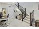 Carpeted staircase with dark wooden railings that ascends to an office space at 12628 Bayshore St, Firestone, CO 80504