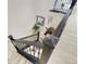 Carpeted staircase with a dark wood railing and landing showcasing a decorative plant and mirror at 12628 Bayshore St, Firestone, CO 80504