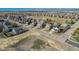 Aerial view of a residential area with houses, roads, trees and a water tower on a sunny day at 6184 Clayton St, Frederick, CO 80530