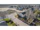 Aerial view of a neighborhood featuring a yellow house with a backyard and a quiet street at 6184 Clayton St, Frederick, CO 80530
