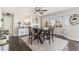 Elegant dining room with a fireplace, bay window, and hardwood floors at 6184 Clayton St, Frederick, CO 80530