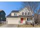 Inviting two-story home with red door, attached garage, and manicured lawn on a sunny day at 6184 Clayton St, Frederick, CO 80530