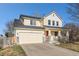 Charming two-story home with a red front door, two-car garage and covered porch at 6184 Clayton St, Frederick, CO 80530