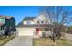 Charming two-story home with a red front door, two-car garage and manicured front lawn at 6184 Clayton St, Frederick, CO 80530