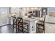 Modern kitchen featuring an island with seating and stainless steel appliances at 6184 Clayton St, Frederick, CO 80530