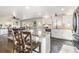 Updated kitchen featuring stainless steel appliances, an island with seating, and ample counter space at 6184 Clayton St, Frederick, CO 80530