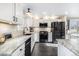 Bright kitchen features stainless steel appliances, granite counters, and white cabinetry at 6184 Clayton St, Frederick, CO 80530