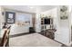 Bright living room showcasing hardwood floors, white trim, and an entertainment center at 6184 Clayton St, Frederick, CO 80530